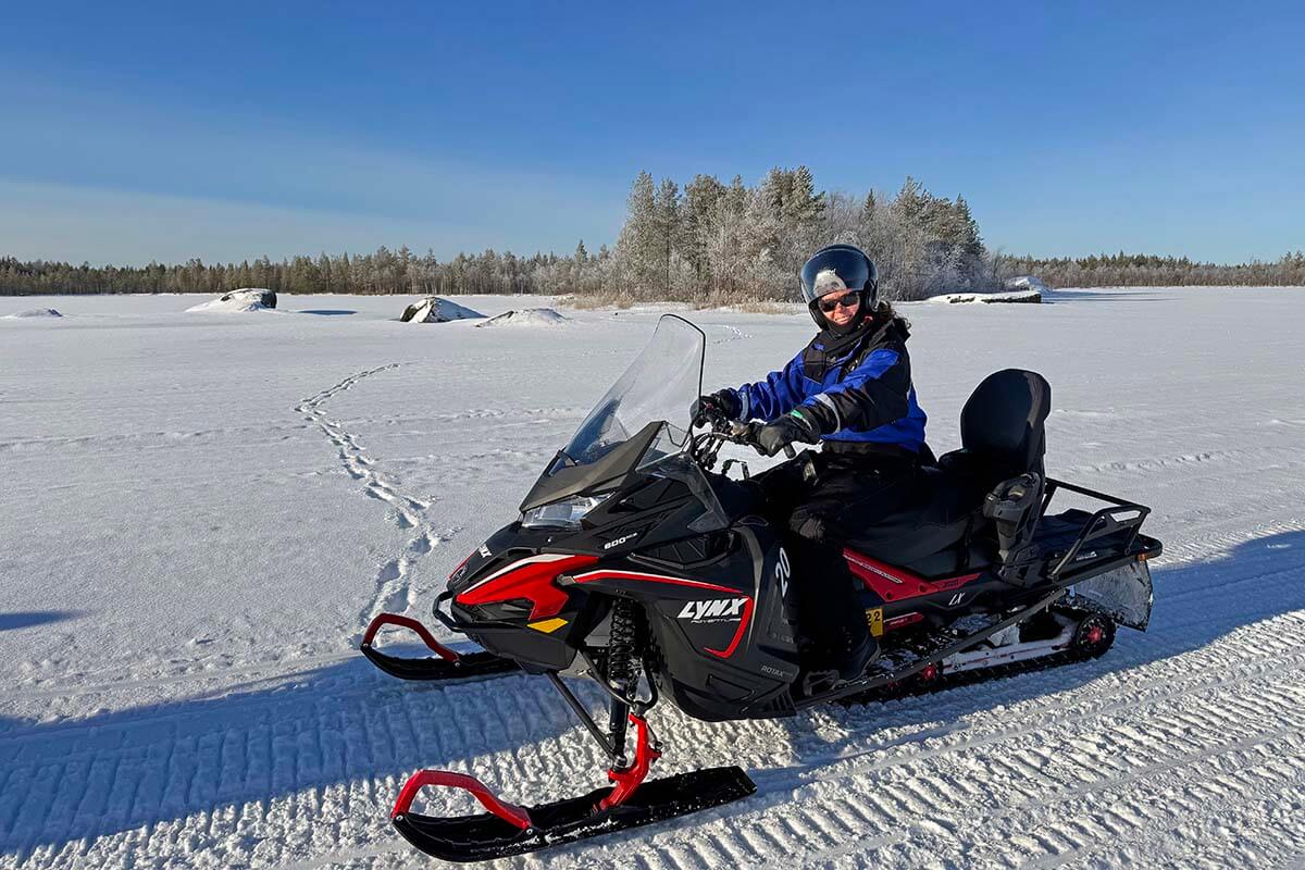 Snowmobiling on a frozen lake at Apukka resort in Rovaniemi in winter