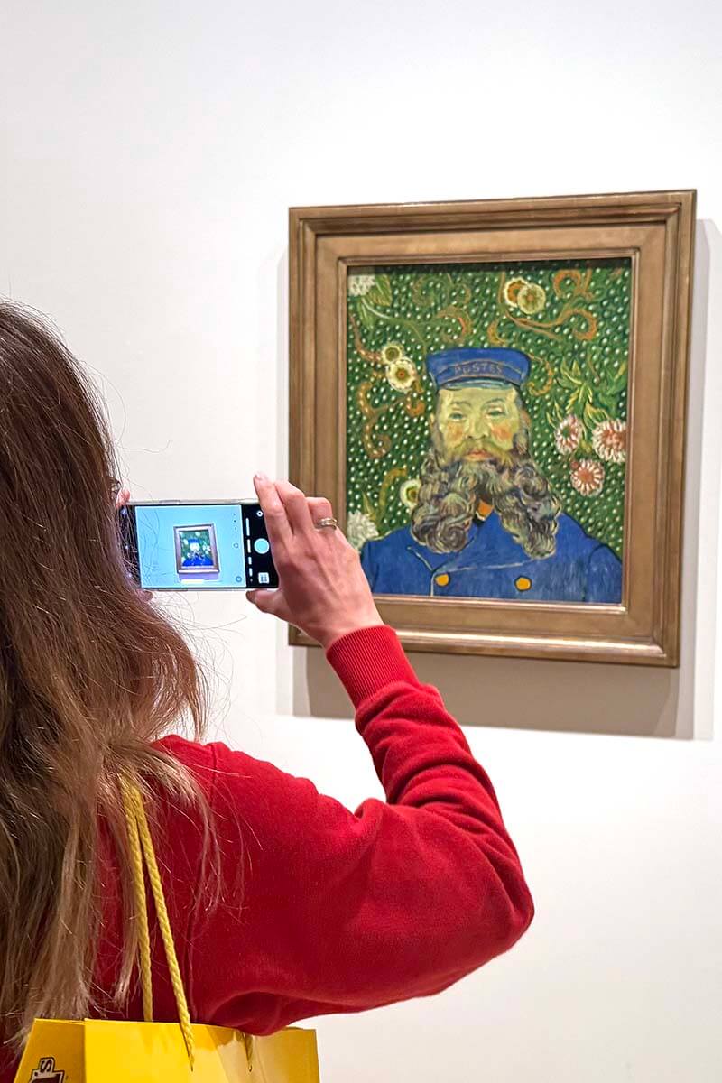 Tourist taking pictures of a painting at MoMA museum in New York City