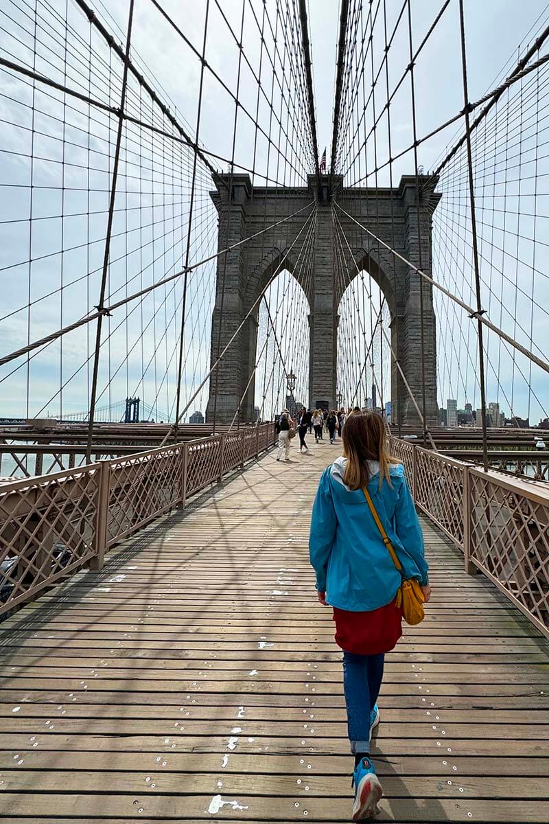 Tourist walking over the Brooklyn Bridge NYC
