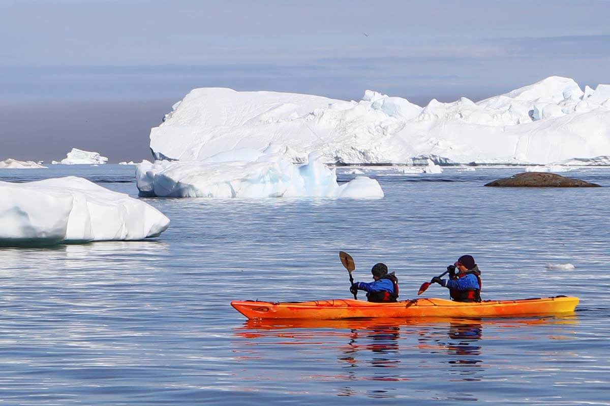 Kayaking between icebergs in Greenland in summer