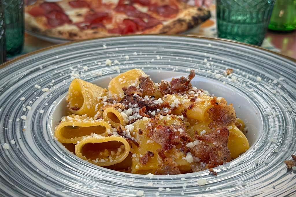 Pasta carbonara and pizza at Villa Carmela restaurant in Albufeira