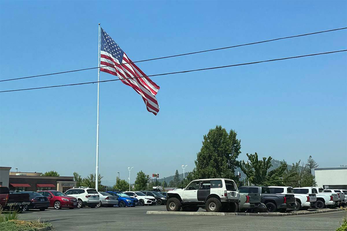 A huge American flag on a parking lot in rural USA