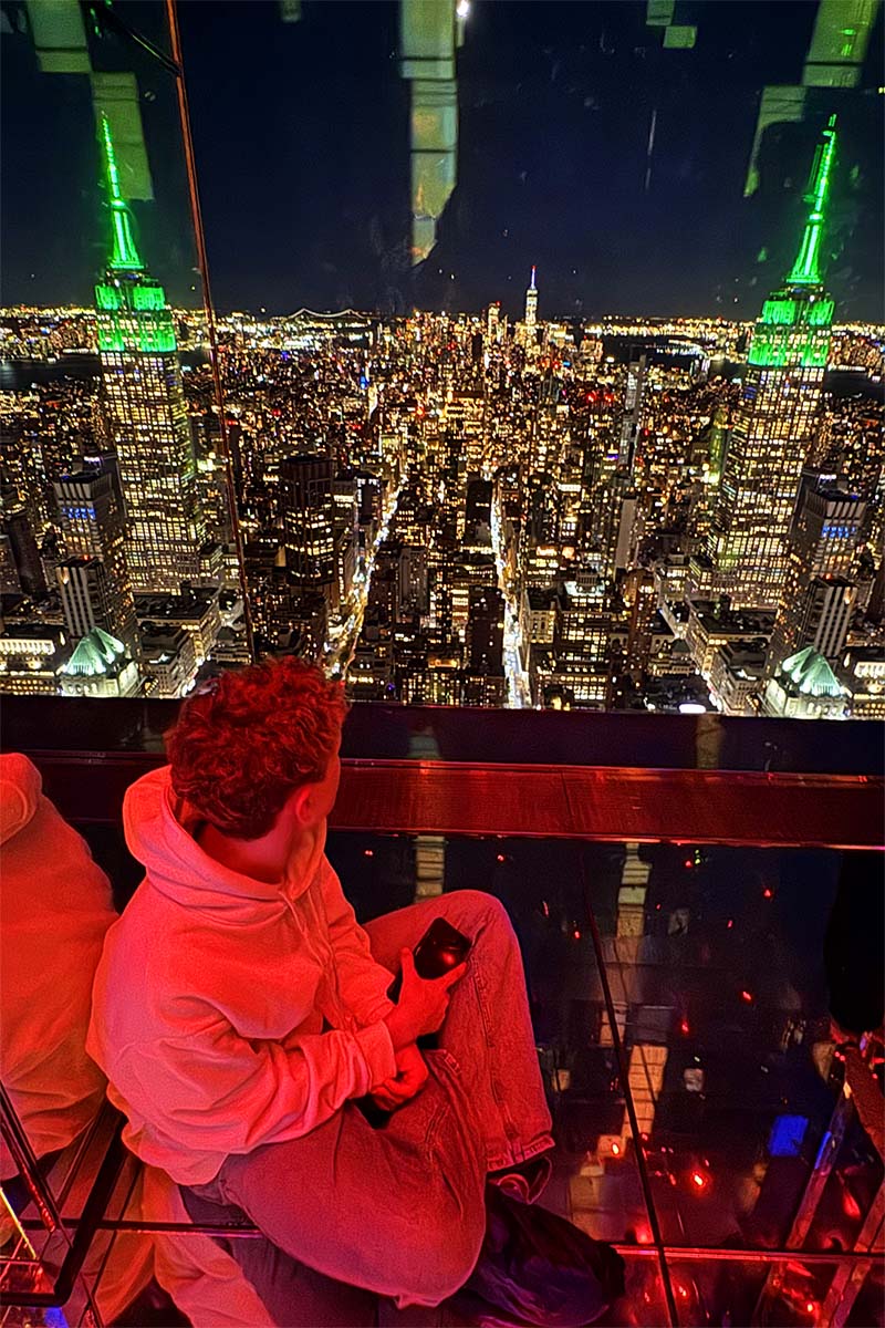 Teenager enjoying night view at SUMMIT One Vanderbilt in New York City