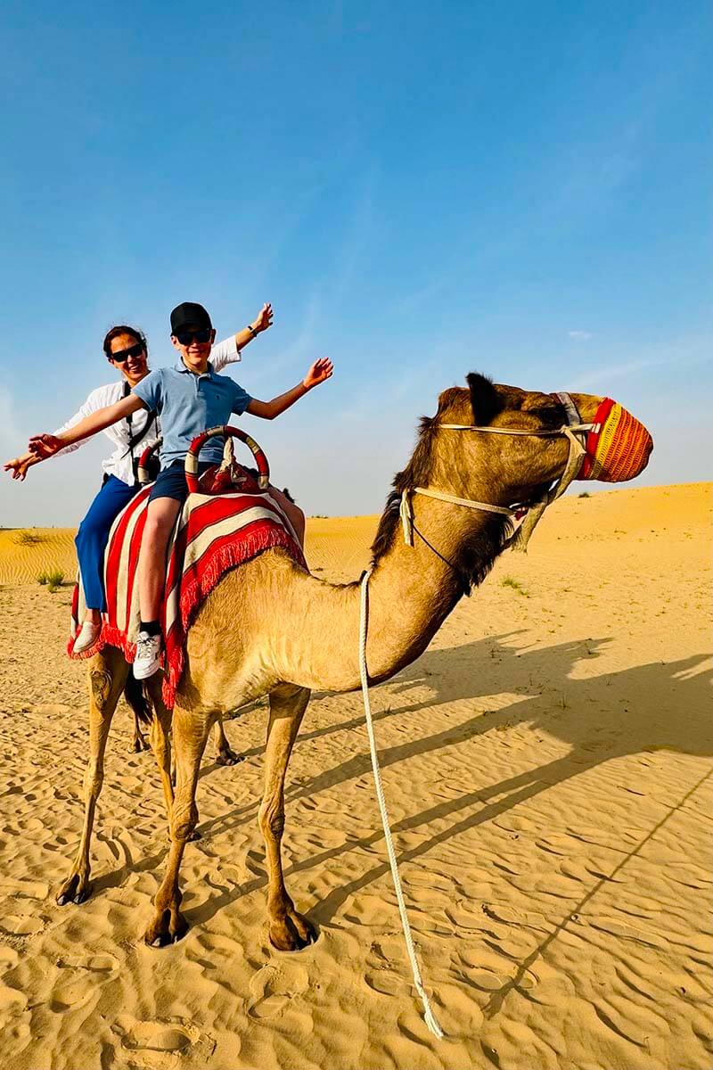 Teenager riding a camel in Dubai UAE