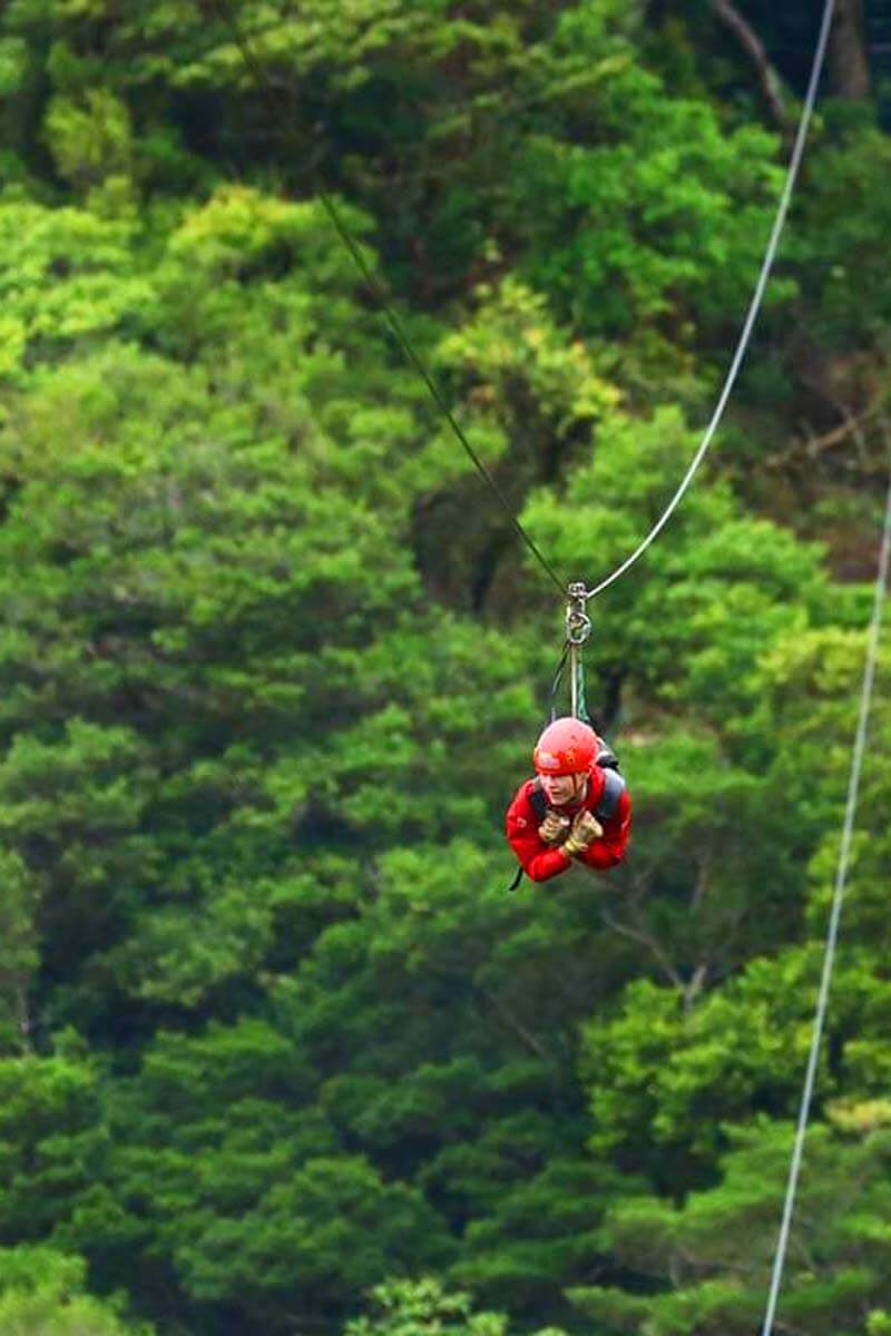 Teenager zip lining in Monteverde cloud forest in Costa Rica