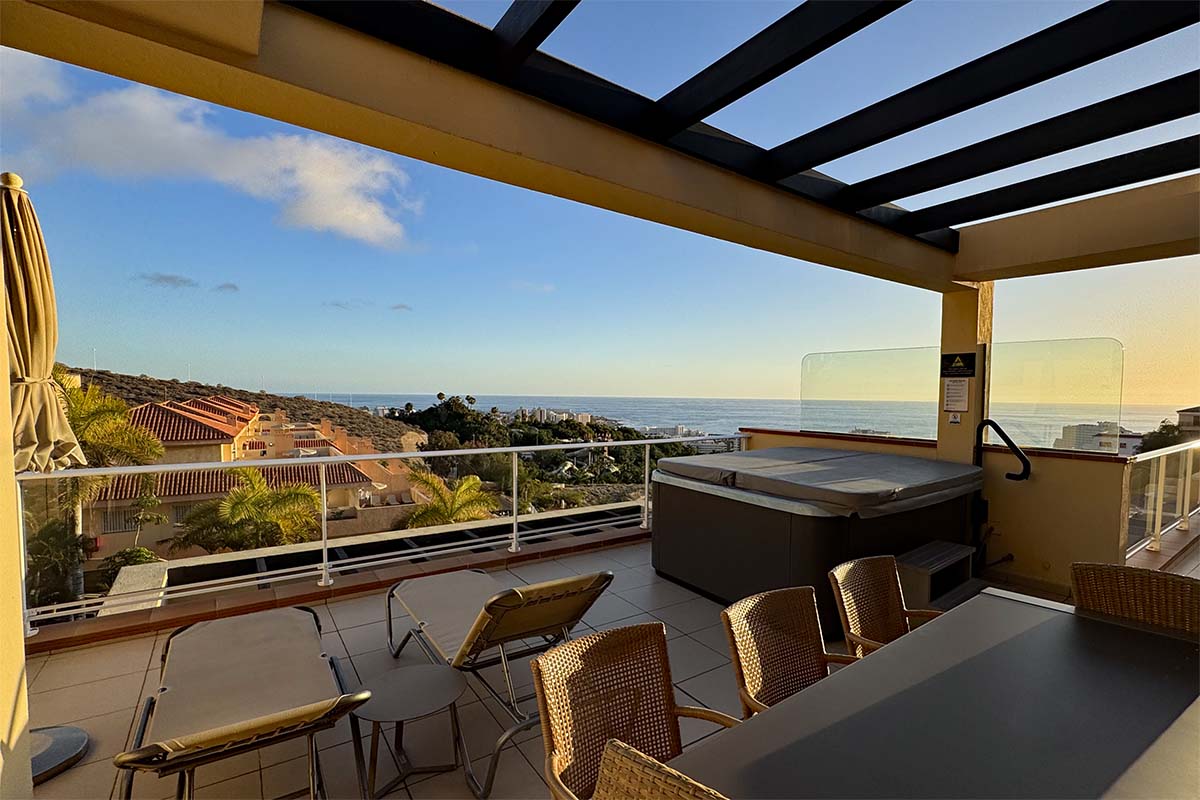 Hotel terrace with a hot tub and sunset sea view at Wyndham Residences Costa Adeje in Tenerife