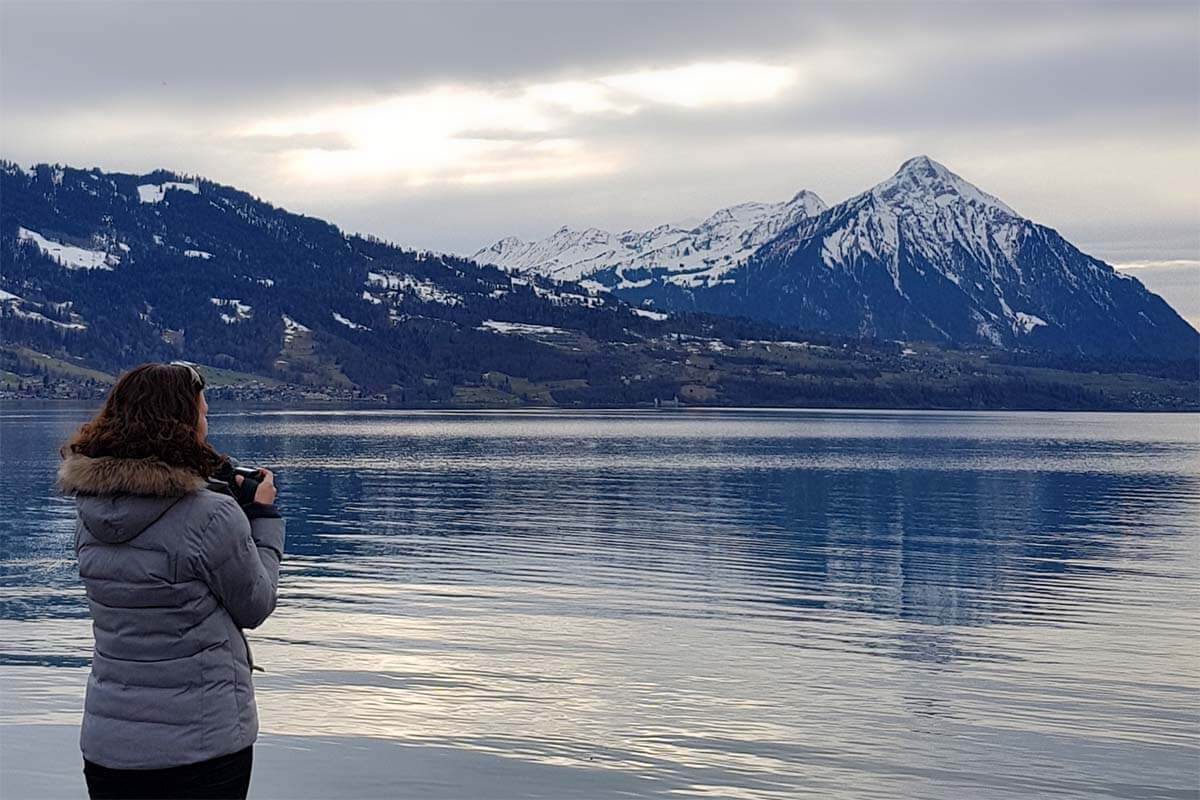 Woman taking pictures at Lake Thun in Interlaken in winter
