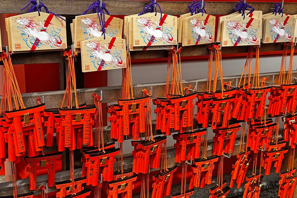 Wooden prayer plaques called ema at Fushimi Inari Shrine in Kyoto Japan