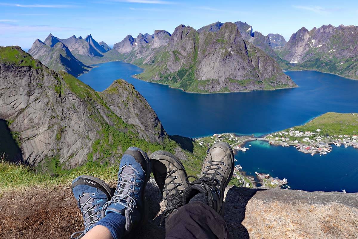Hiking boots overlooking Reinefjord and Reine from Reinebringen in the Lofoten Islands, Norway