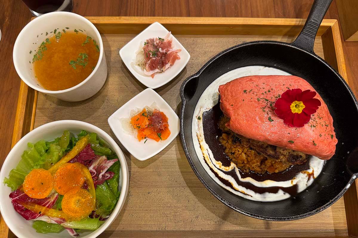 Japanese dinner set meal at JOYS TABLE in Kyoto, including a local hamburger steak and pink omelet