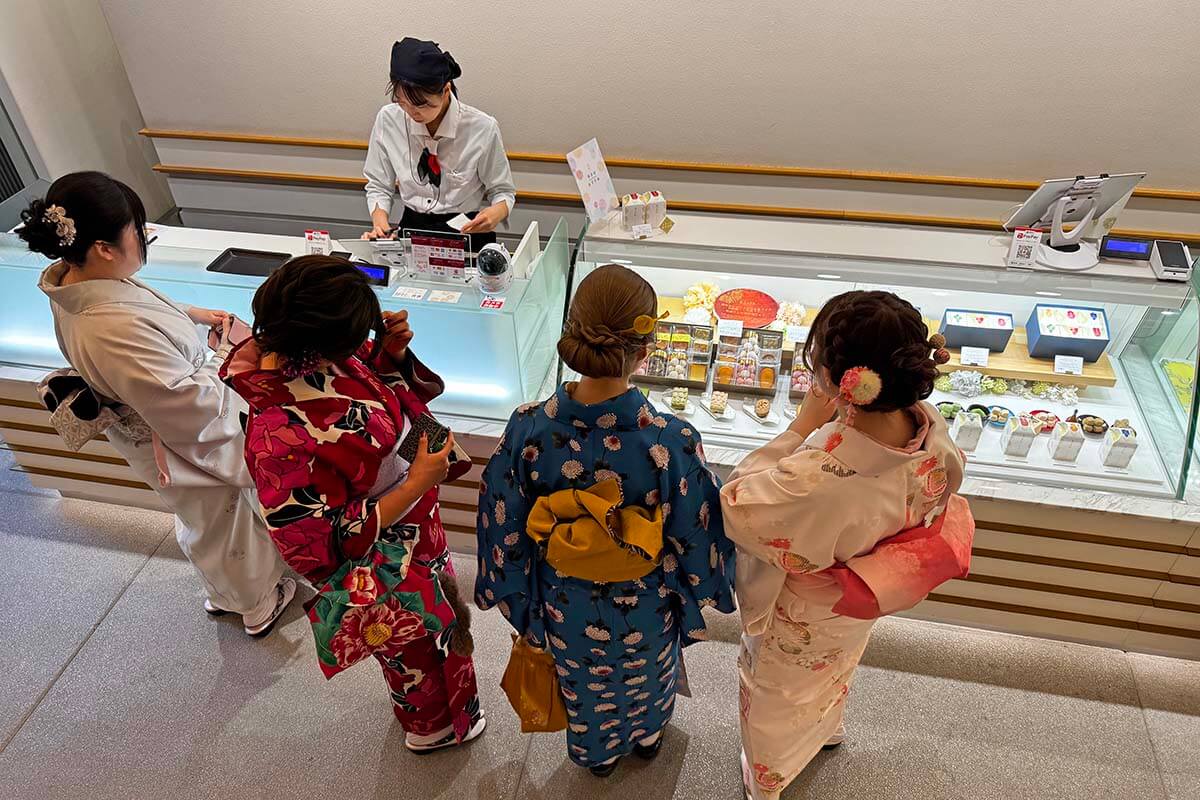 Japanese women in colorful kimonos choosing pastries at Patisserie Gion Sakai in Kyoto