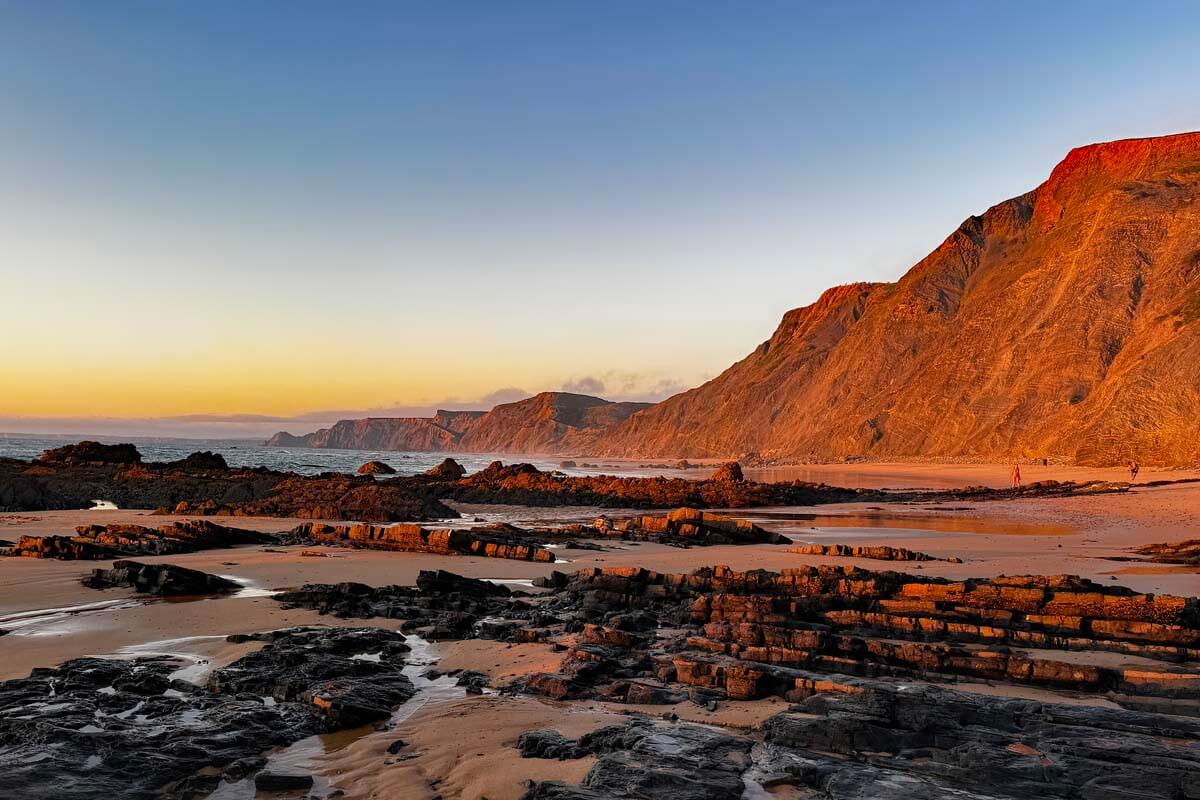 Algarve coastline at Praia da Cordoama as seen from Praia do Castelejo at sunset in summer