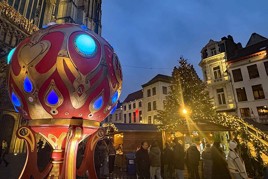 Colorful Christmas ornament and market stalls at Handschoenmarkt near Antwerp Cathedral.