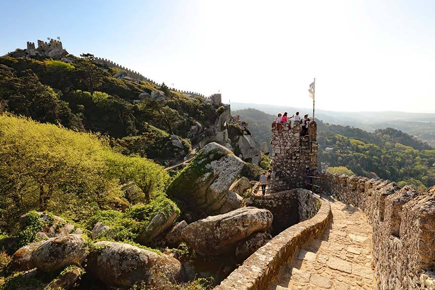 View from the Moorish Castle in Sintra with castle walls, towers, and surrounding hills.