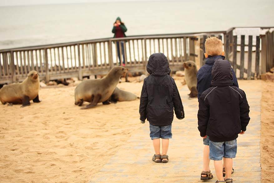 Kids wearing rain jackets and sandals at Cape Cross Seal Colony in Namibia