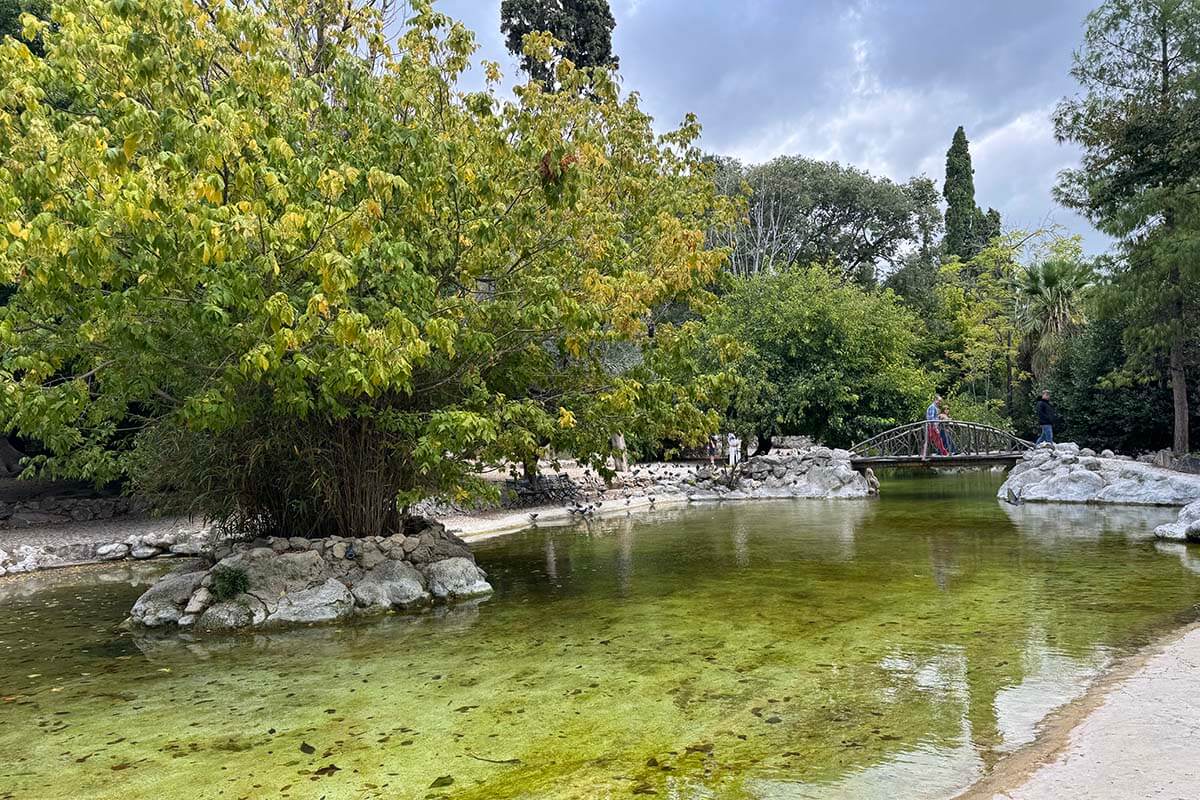 A pond with a small bridge at the National Garden in Athens