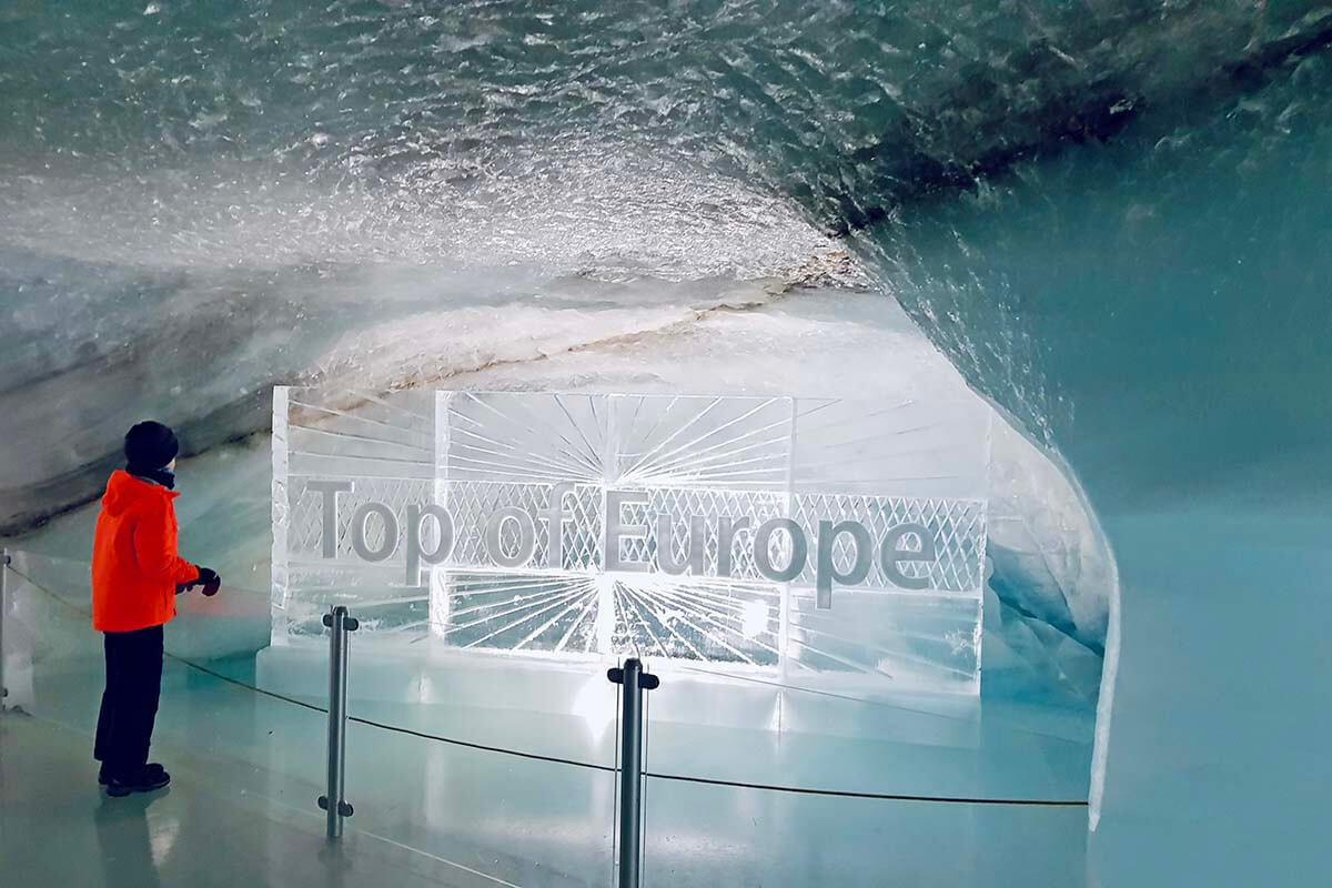 Child at the Top of Europe sign inside an ice tunnel at Jungfraujoch in Switzerland